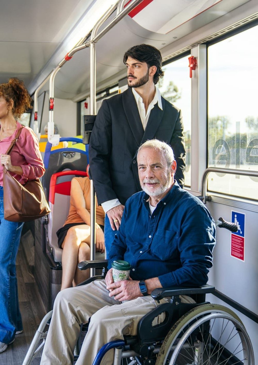 a senior man in a wheelchair riding a modern city bus enjoying accessible public transport